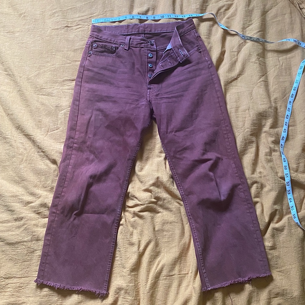 Broken in Levi’s maroon jeans with raw hems